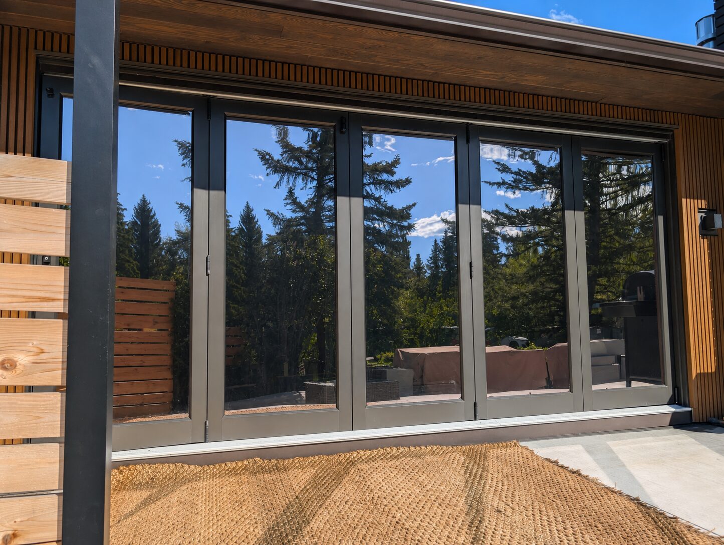 Reflective solar window film installed on folding patio doors in Britannia SW Calgary