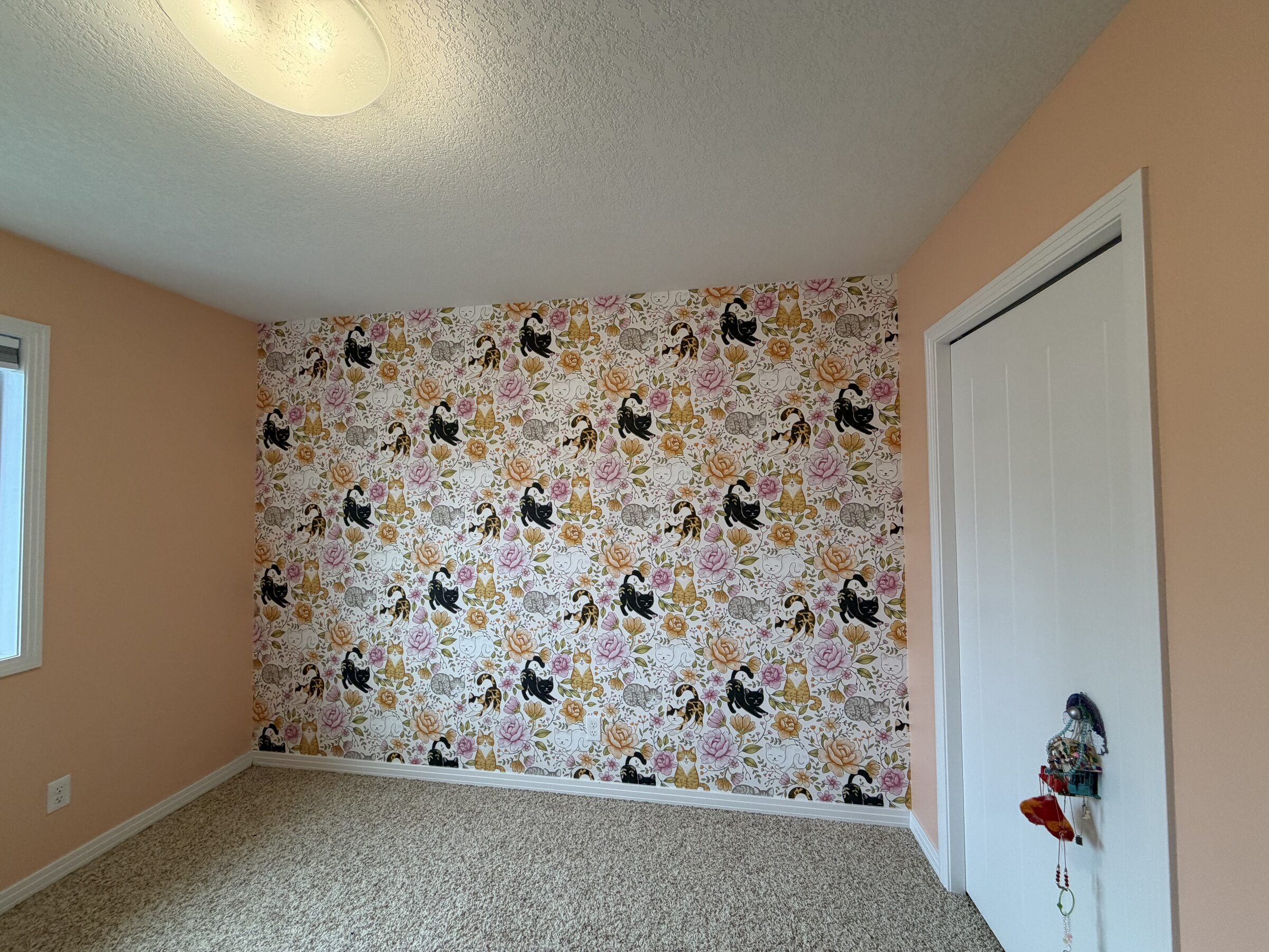 Vintage botanical cat wallpaper feature wall behind the closet in a bedroom in Auburn Bay, SE Calgary