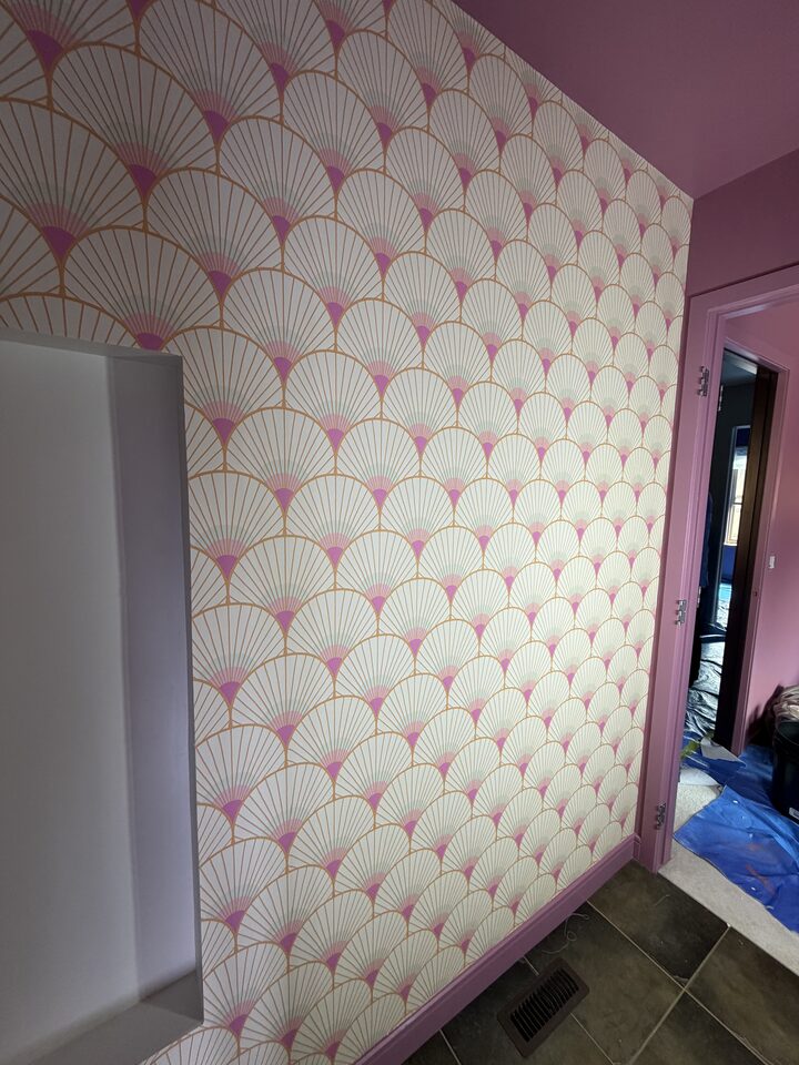 Wide view of art deco fan wallpaper covering a Canmore bathroom ceiling with rose-pink walls