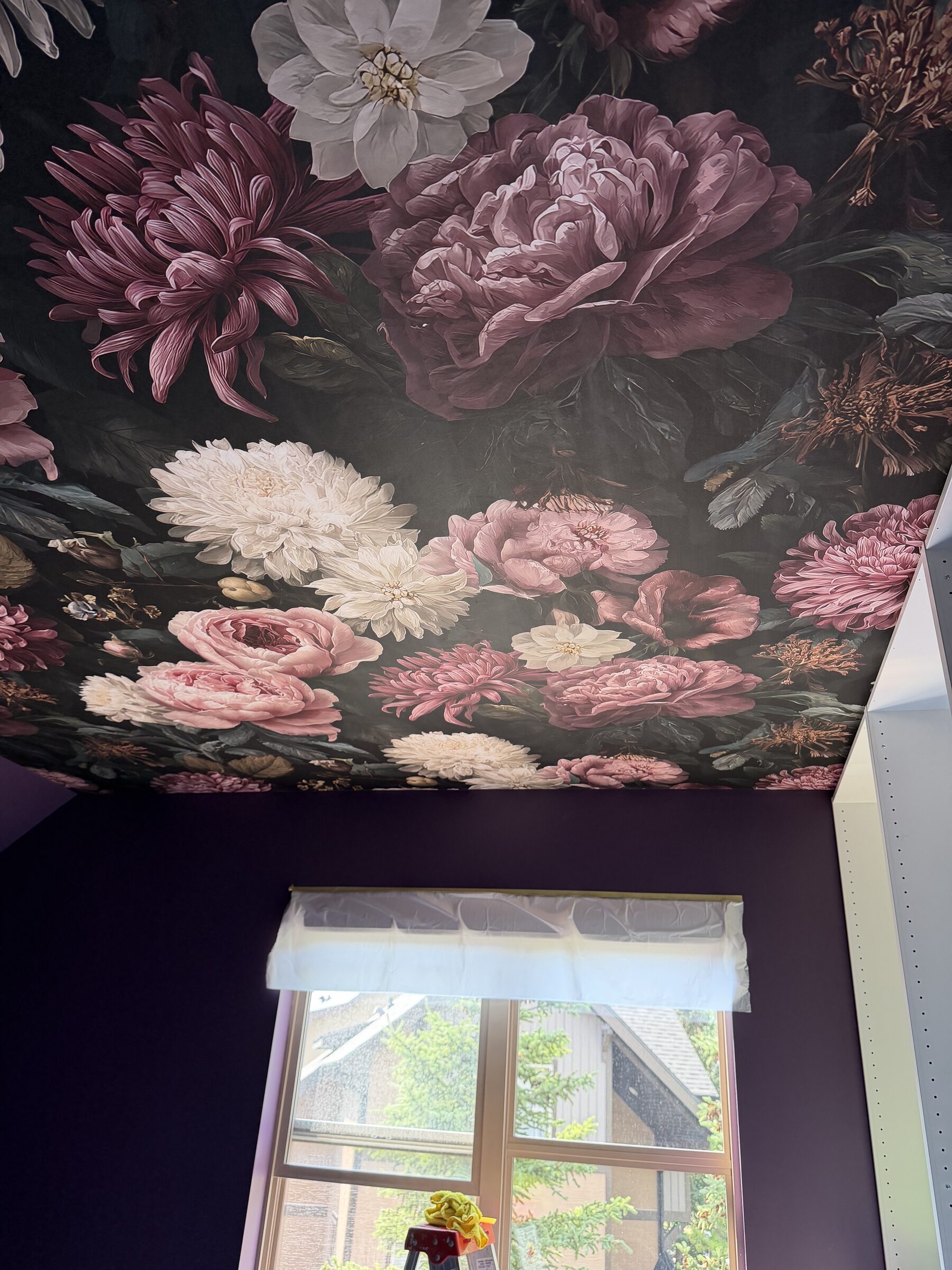 Dark floral mural wallpaper with blush peonies on a dressing room feature wall in Canmore, AB