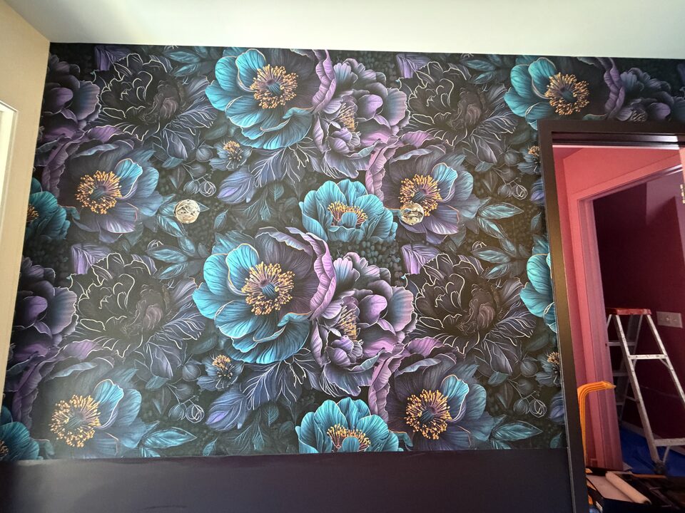 Jewel-tone teal peony mural wallpaper feature wall with gold outlines in a Canmore bedroom