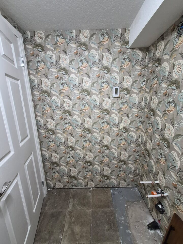 Botanical peel-and-stick wallpaper installed around a bathroom doorway in Chinook Park Calgary