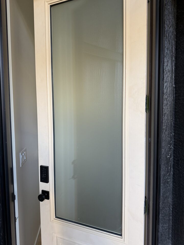 Exterior view of frosted privacy film on a Collingwood front door beside the keypad lock