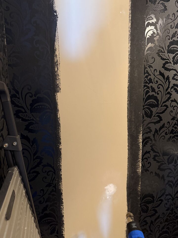 Powder room wall prepared for a black damask wallpaper repair in Heritage Pointe