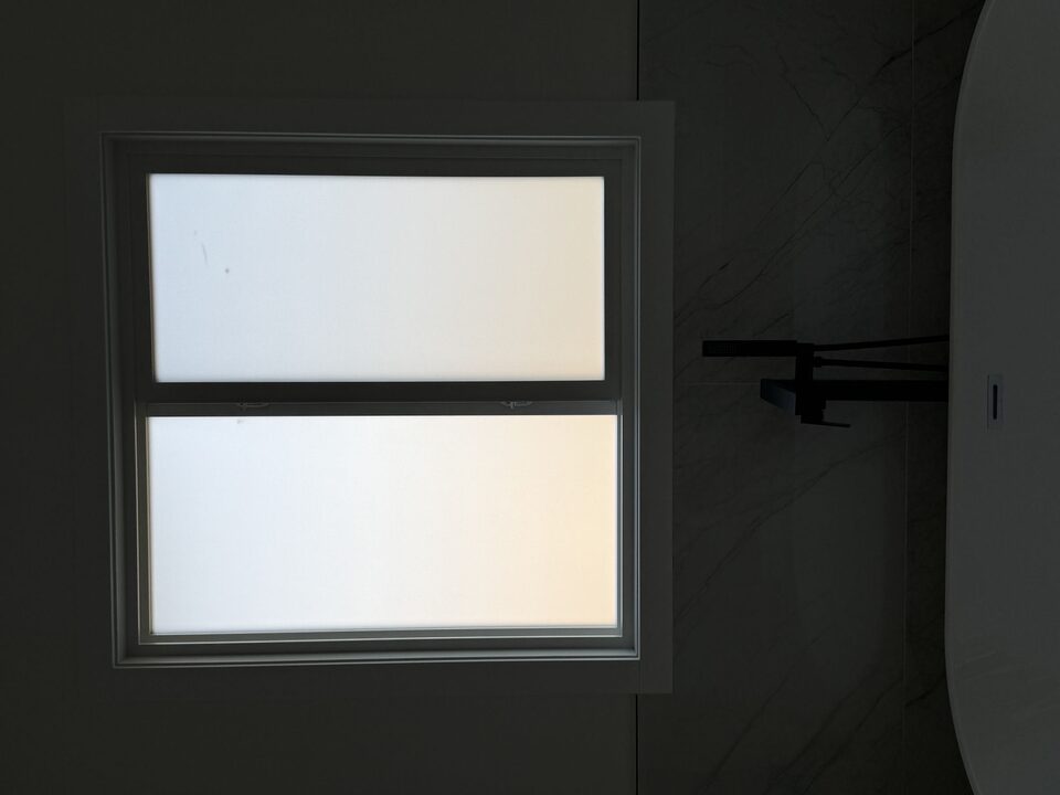 Silver Tech frosted privacy film on both sashes of a bathroom window in Legacy, SE Calgary