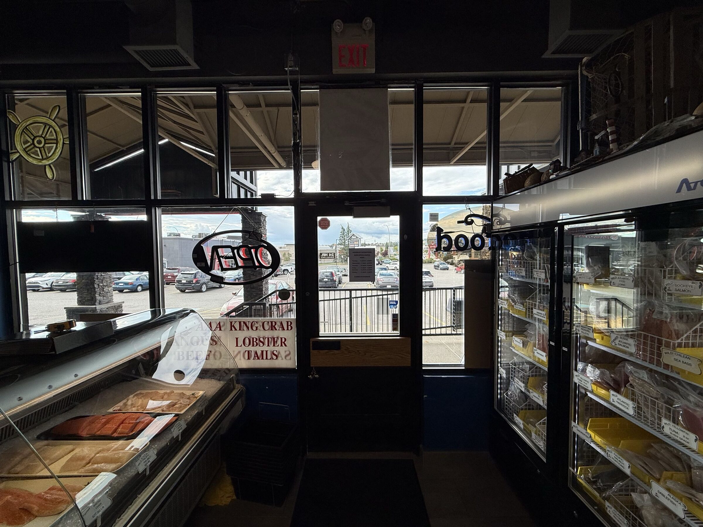 Commercial solar-control window film on the North Sea Fish Market Crowfoot entry glazing in Arbour Lake, NW Calgary