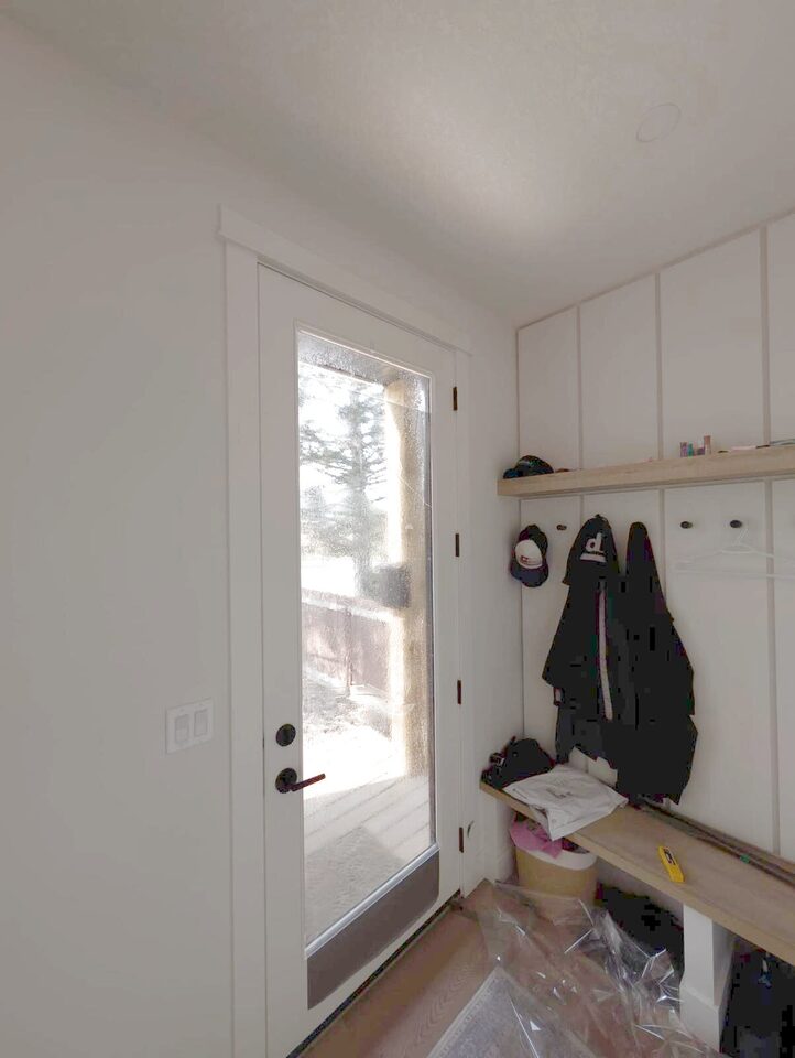 Mudroom door glass with dual-reflective DR 37 window film curing after installation in Bowness, NW Calgary