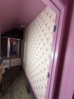 Case study: art deco fan wallpaper installed on a Canmore bathroom ceiling and niche wall, papering the fifth wall above a shower with rose-