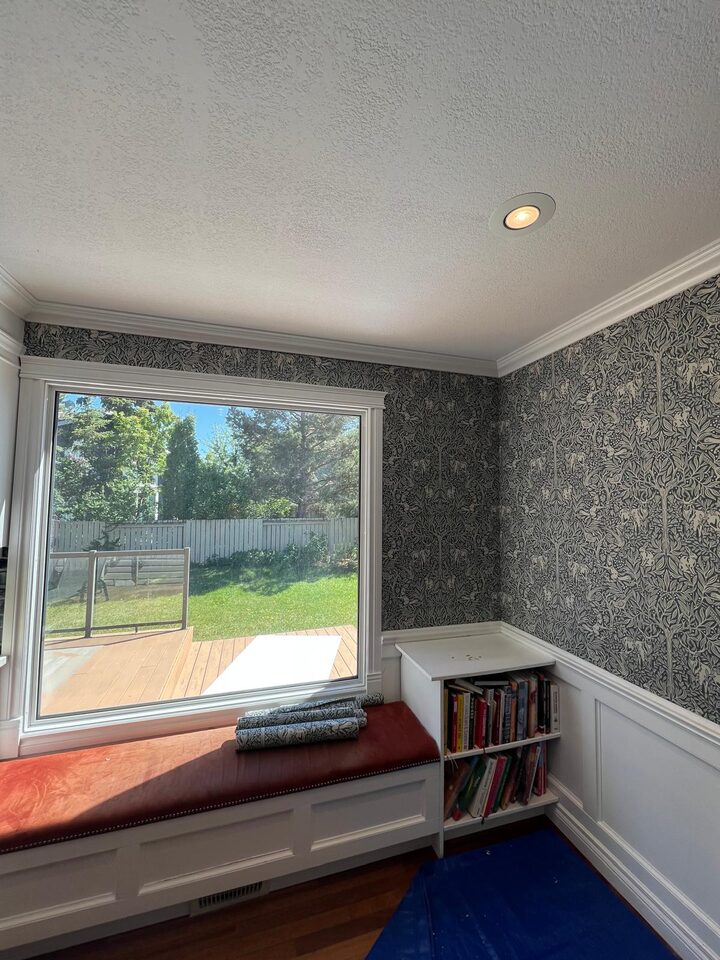 Full window corner view after blue botanical wallpaper installation in a Deer Run SE Calgary dining room