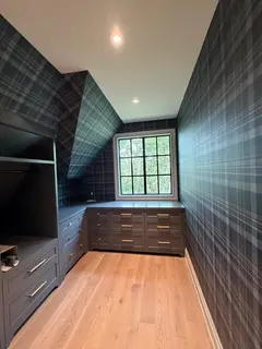 Case study for navy tartan plaid wallpaper in an Elbow Valley walk-in closet - matched up the walls and across the sloped dormer ceilings we