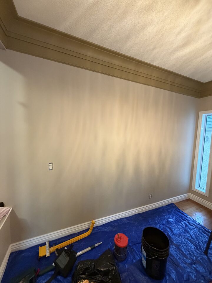 Evergreen, Calgary dining room wall before the floral mural, painted beige with drop cloth and installation tools on the floor
