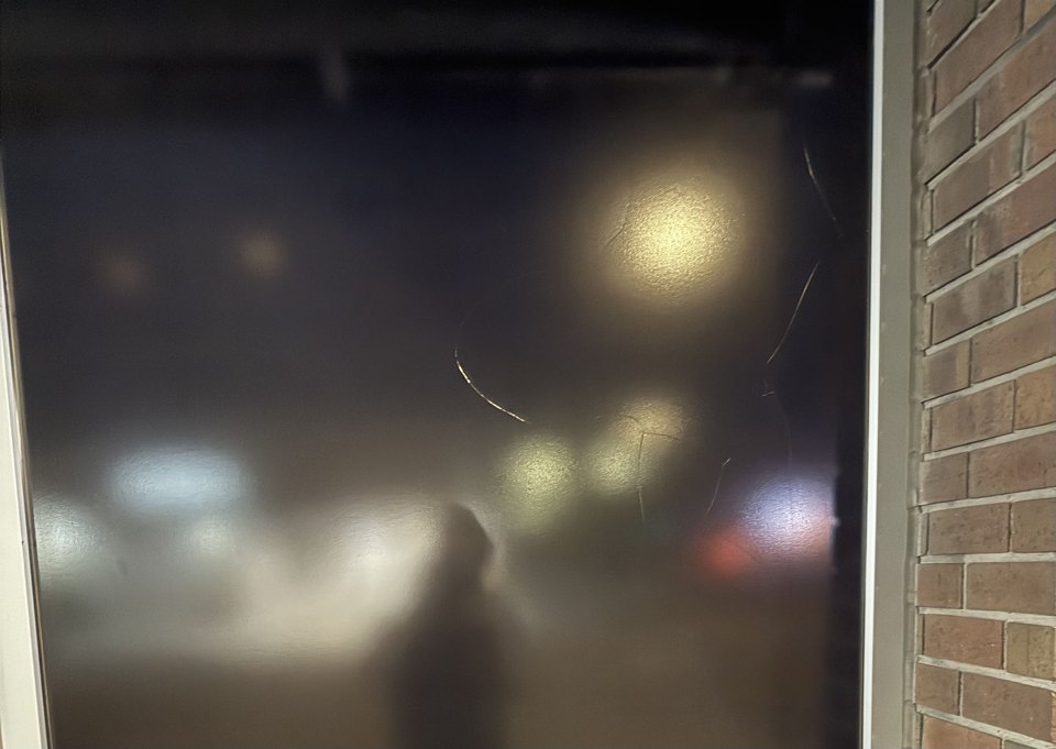 A filmed window pane with visible cracks