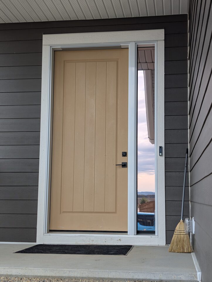 After photo of solar and security window film installed on a front entry sidelite in Harmony Rocky View County