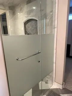 Frosted privacy film on a clear glass shower in Heritage Pointe south of Calgary - a laser-set frost band across door and panel, no glass re