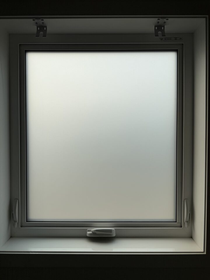 Bathroom casement window covered edge to edge with Silver Tech frosted privacy film in a Mahogany SE Calgary new build
