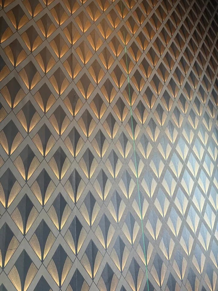 Art deco diamond fan wallpaper wrapped around a powder room corner in Patterson, SW Calgary