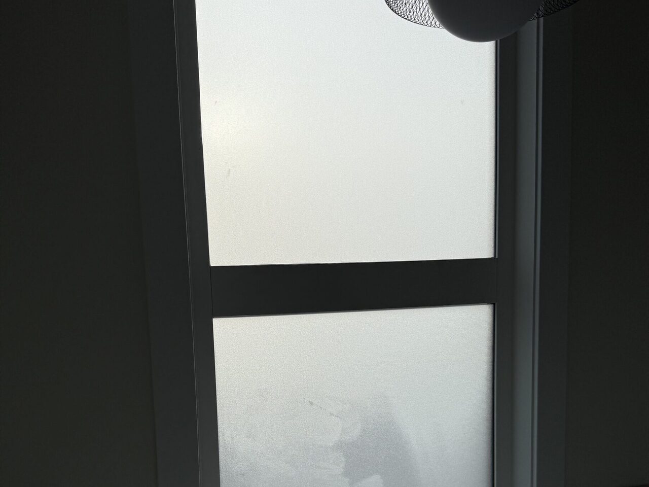 Frosted privacy window film on a residential bathroom window in Calgary