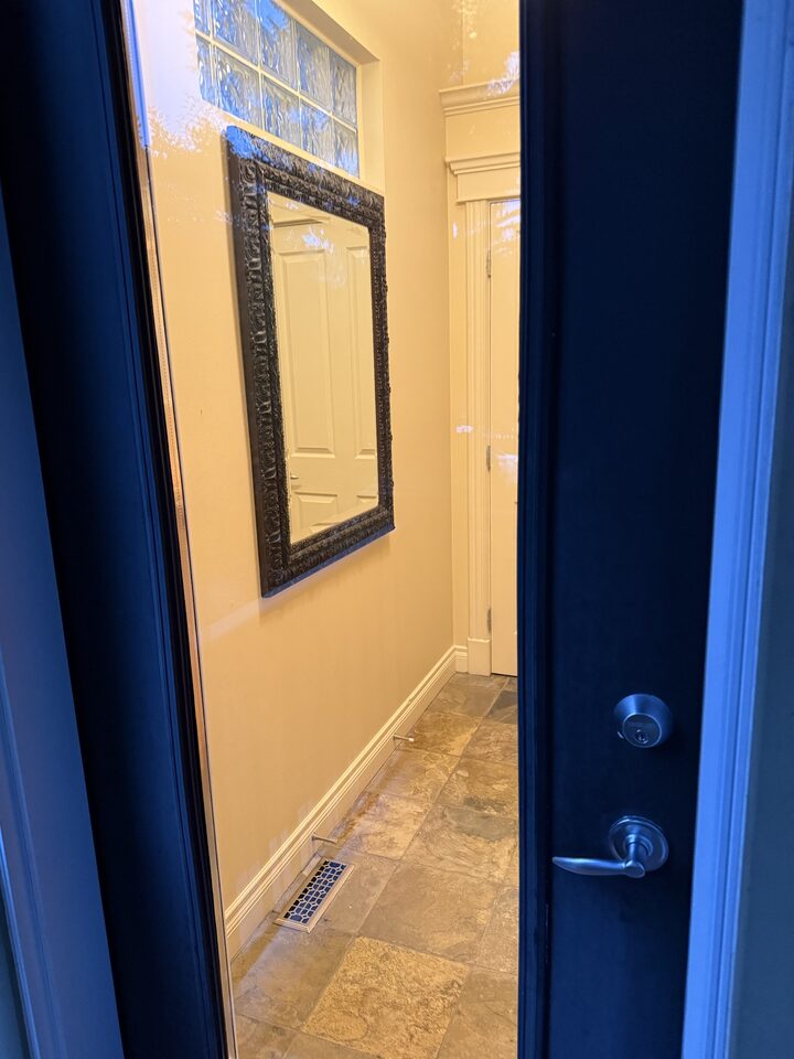 Navy front door and sidelight glass finished with clear security window film in South Calgary, SW Calgary