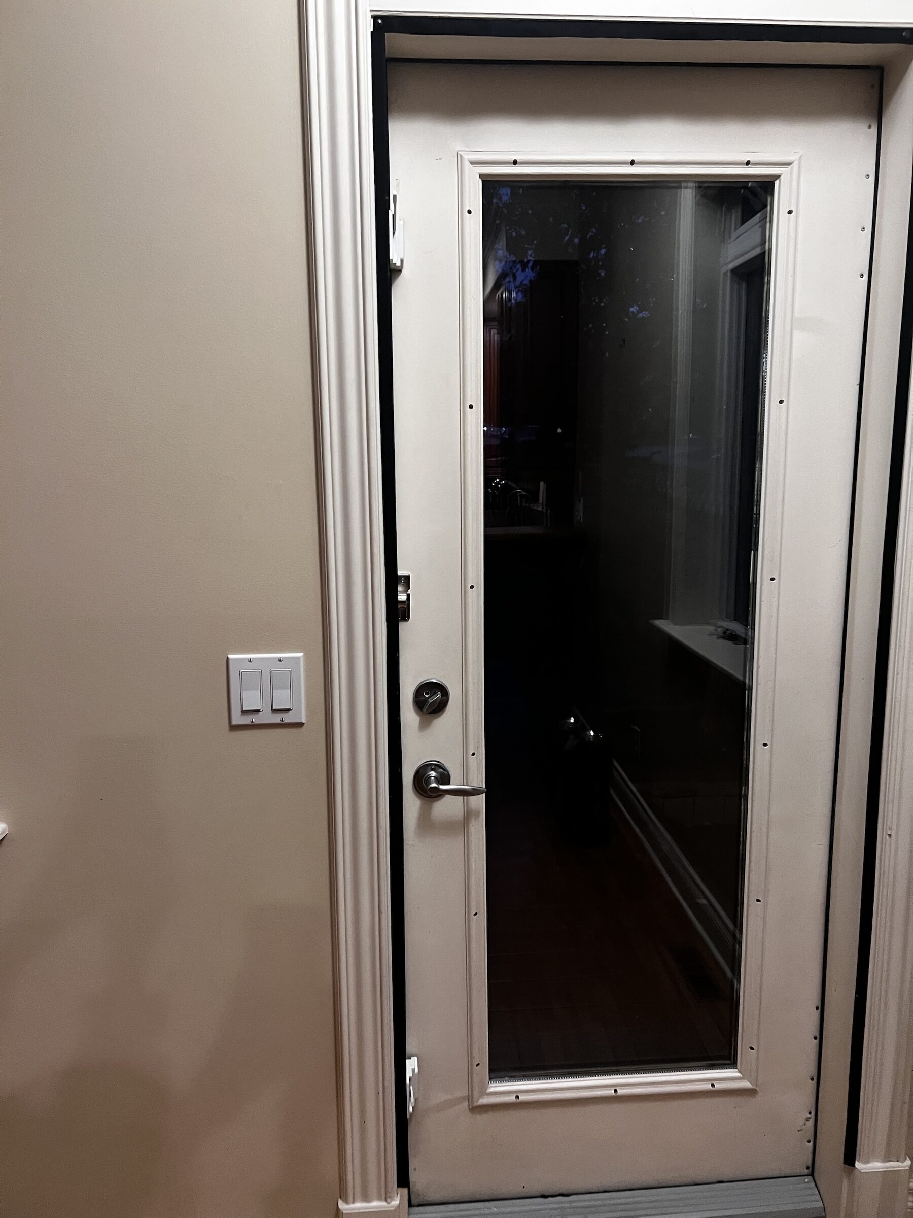 Full-lite back entry door glass protected with clear safety and security window film in South Calgary, SW Calgary