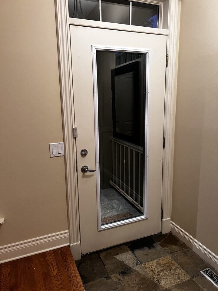 Side entry door with transom window, glass panel filmed with clear safety and security film in South Calgary, SW Calgary