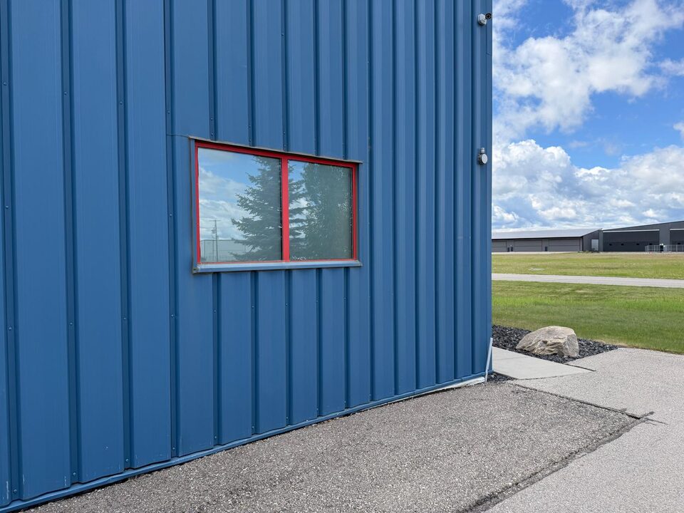 Frosted privacy window film on an airplane hangar side window near Springbank Airport
