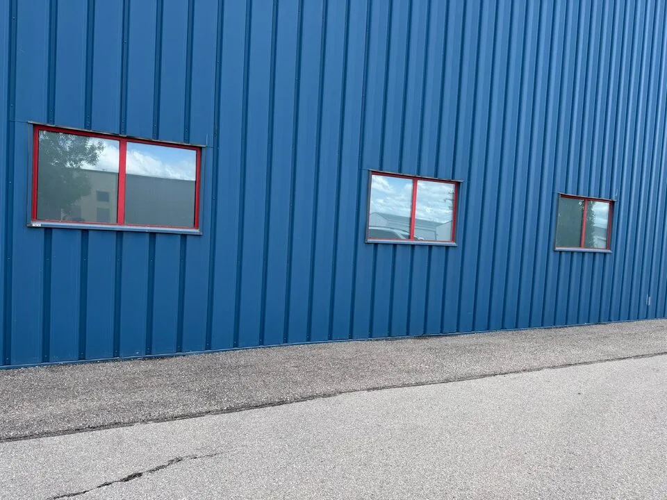 New frosted privacy window film installed across airplane hangar exterior windows near Springbank Airport