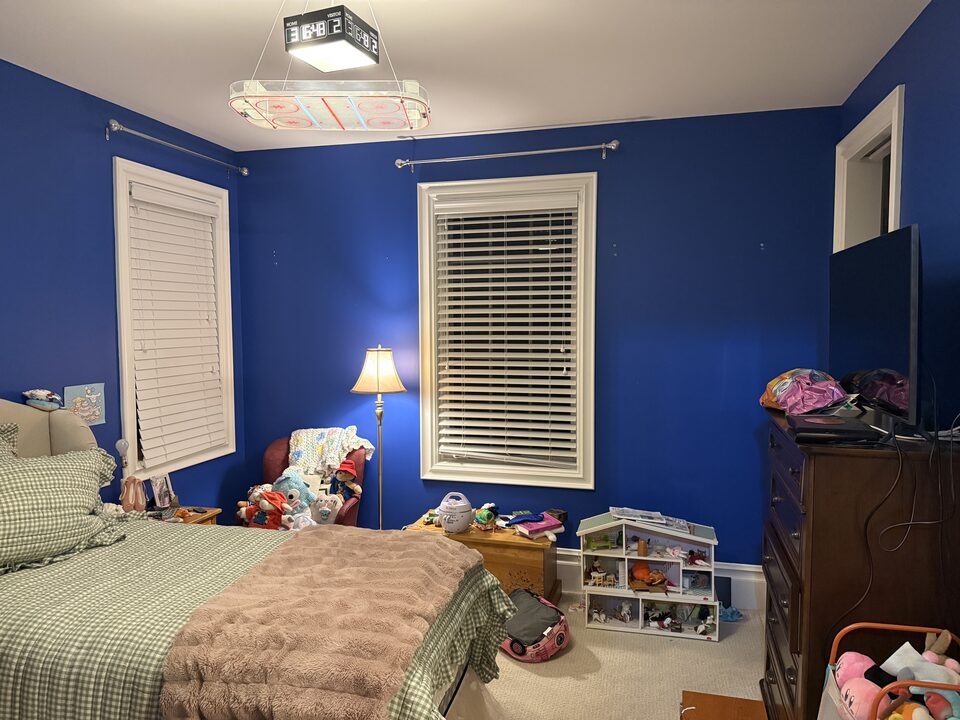 Kids bedroom window wall painted royal blue before wallpaper installation, Springbank near Calgary