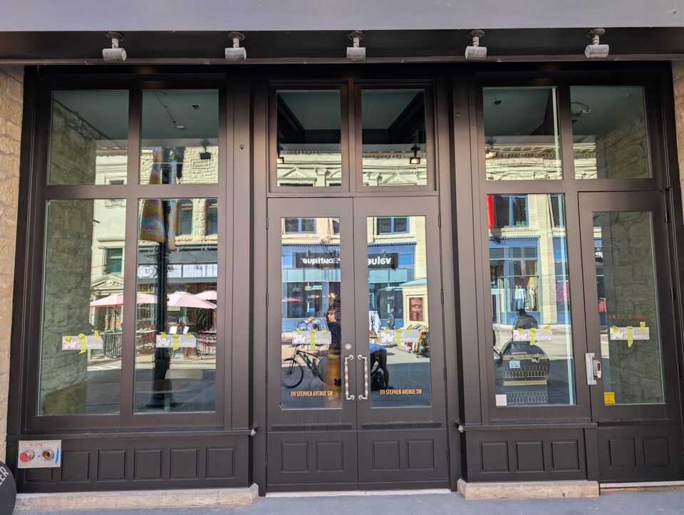 Framed entrance doors and upper glazing on the Stephen Avenue commercial solar-film project