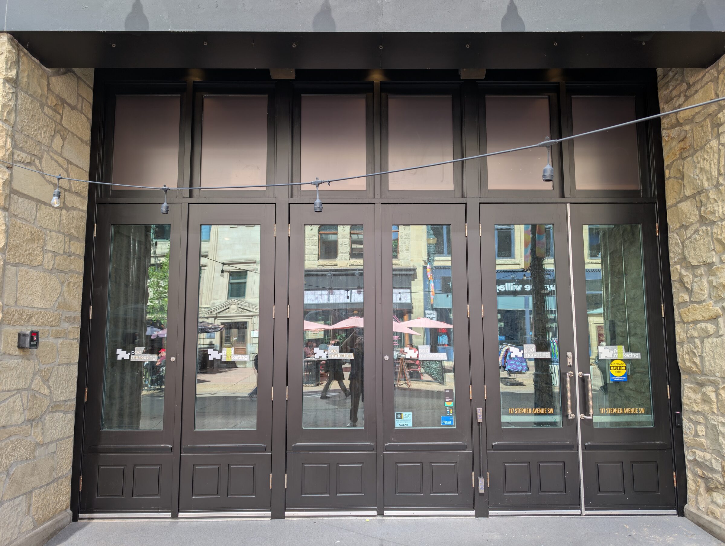 Wide exterior view of the Stephen Avenue storefront after the commercial solar-film work