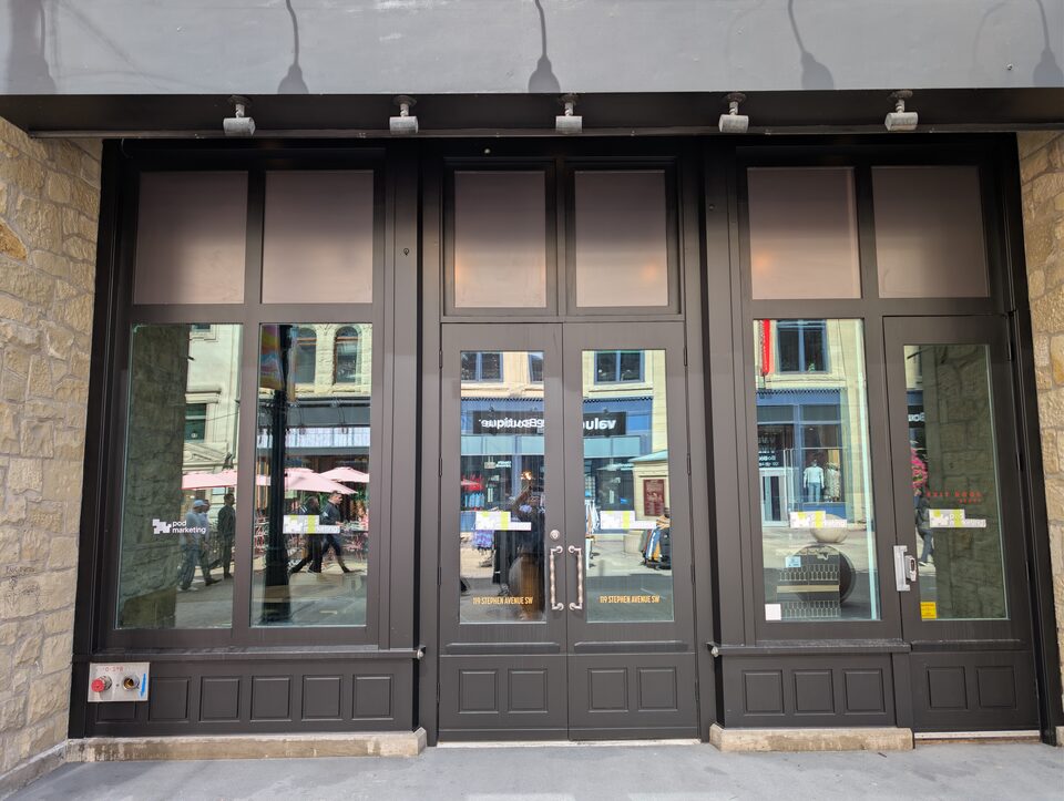 Street-facing exterior view of the completed commercial solar-film project in Downtown Calgary