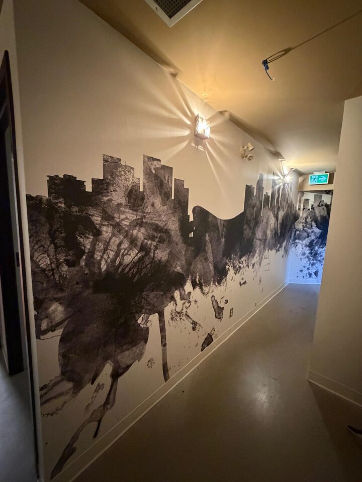 Custom printed Calgary skyline mural wallcovering along a downtown Calgary commercial corridor after installation by Wall Style Innovations