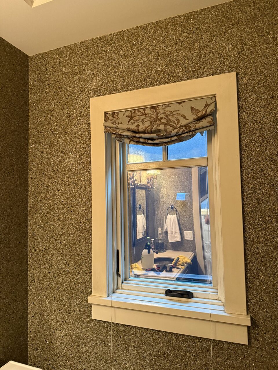 Bathroom window during the Upper Mount Royal project. Interior reflections and installation supplies are visible; no before/after or performance comparison is implied.