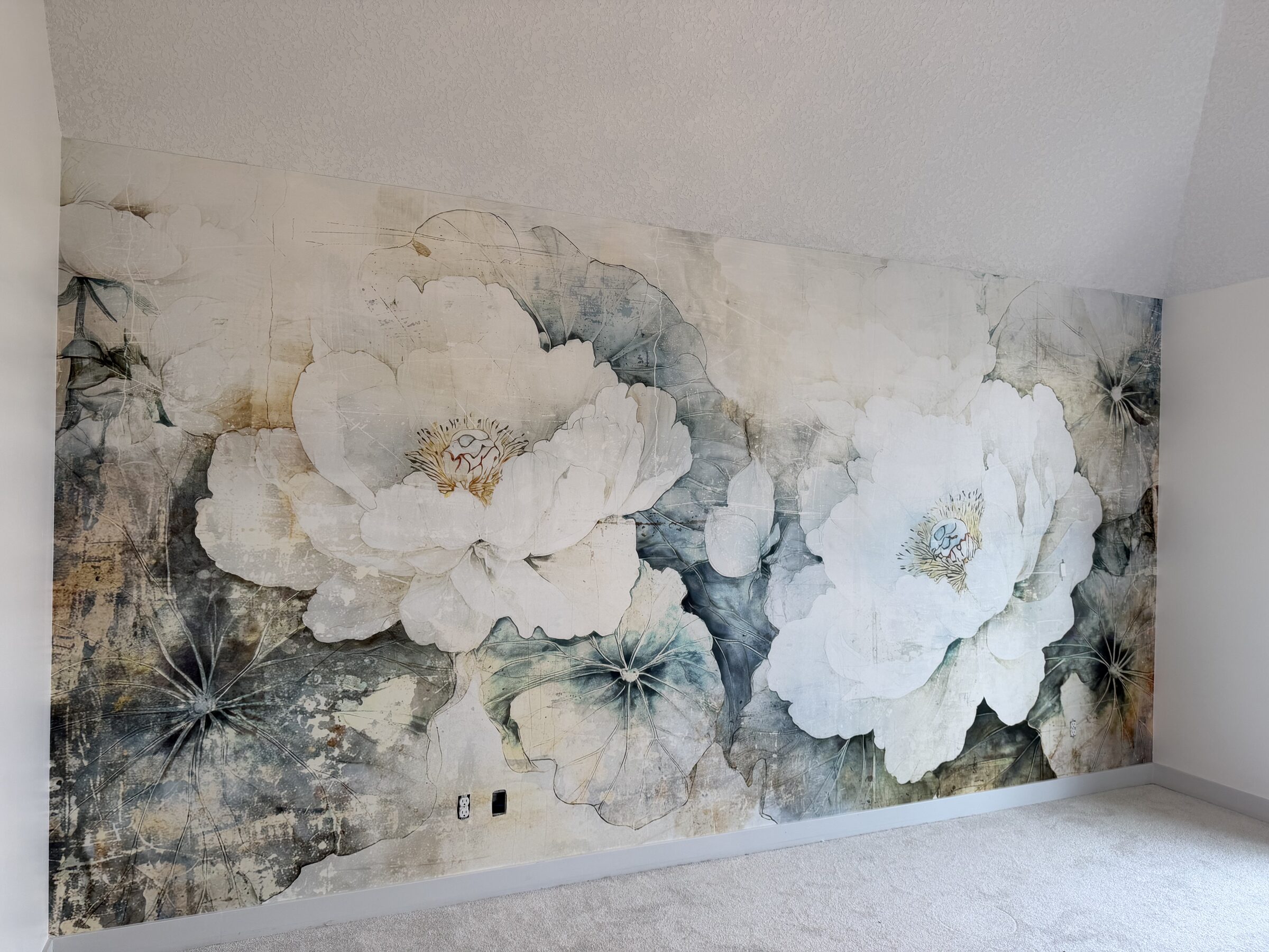 Oversized white peony mural wallpaper across a bedroom feature wall with a sloped ceiling in Winston Heights, NE Calgary